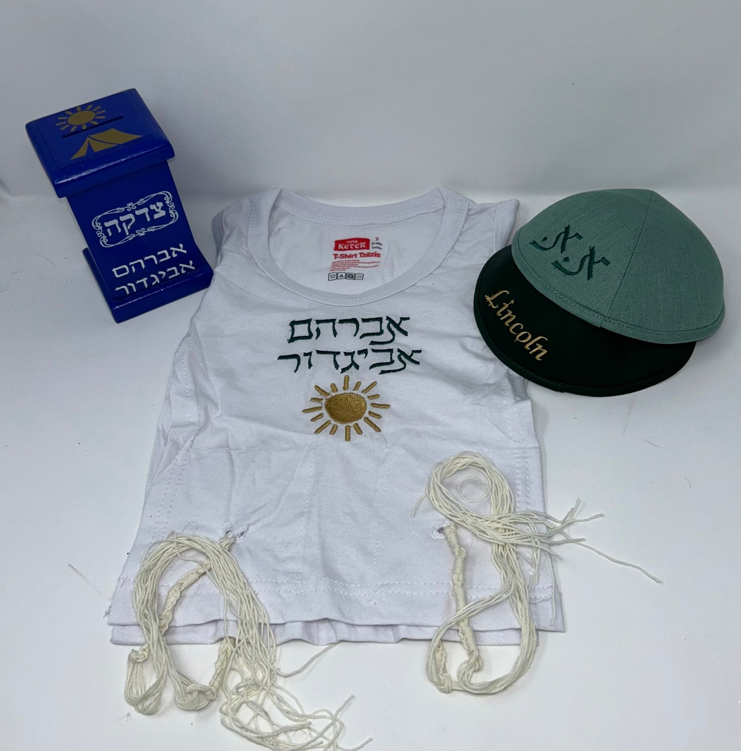 Tzitzis + 2 kippahs + tzdakah pushka